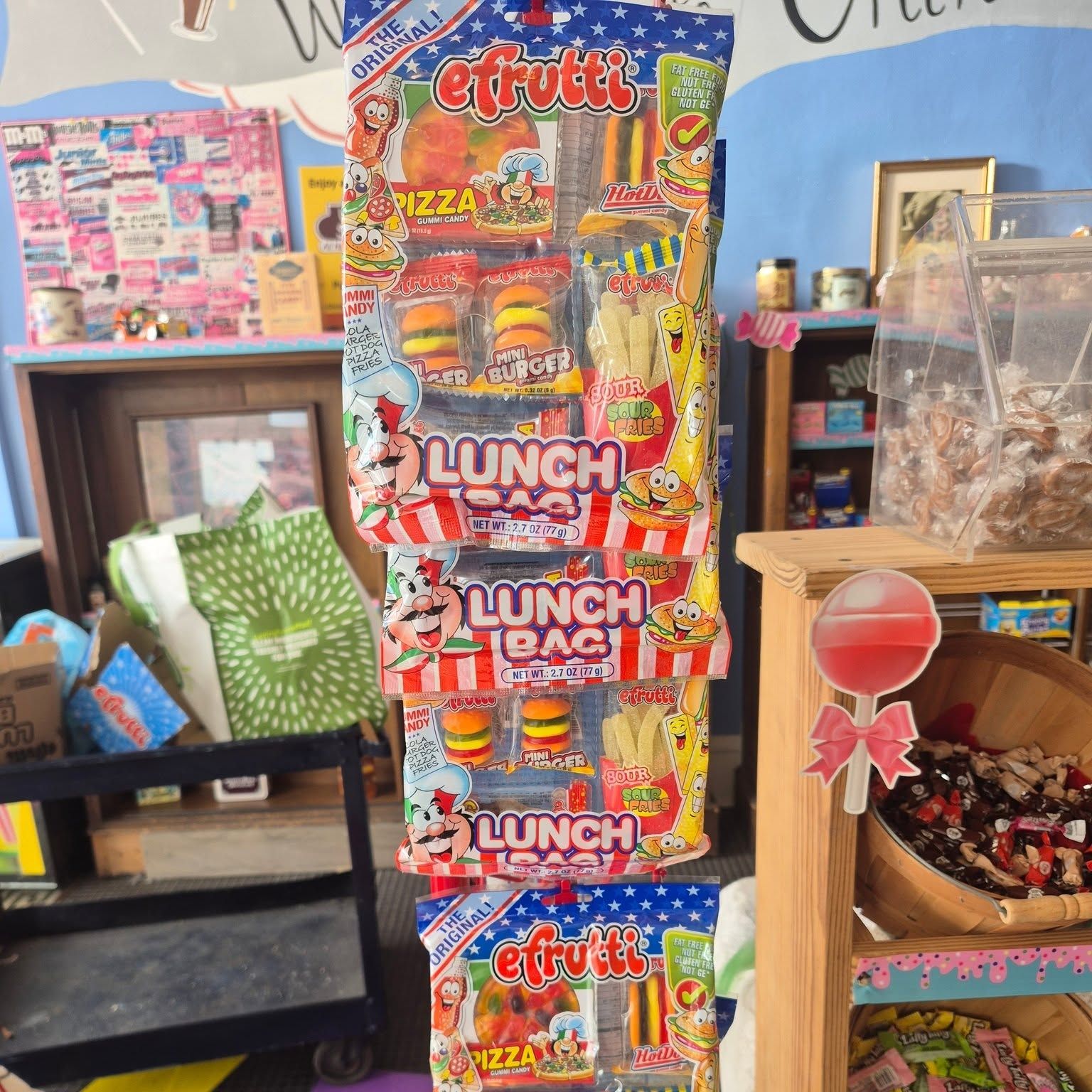 Aisle of candy racks stocked floor to ceiling at The Candy Shoppe on Main
